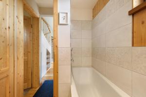 a bathroom with a bath tub and a staircase at Ostseeseele in Parin +21 photos