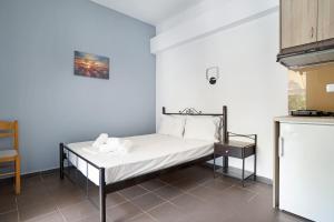 a small bedroom with a bed in a kitchen at Iguana studio 8 in Preveza