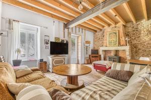a living room with a couch and a table at Maison calme d'Amélie in Saint-Germain-dʼEsteuil