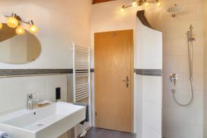 a bathroom with a sink and a shower at Ferienwohnung Bergkristall in Grainau +23 photos
