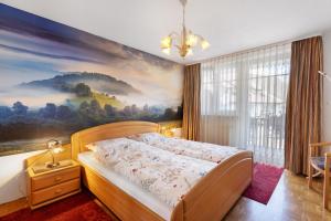 a bedroom with a bed with a painting on the wall at Ferienwohnung Südschwarzwald in Bräunlingen