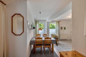 a kitchen and dining room with a table and chairs at Möve Aba Appartment 22 in Rerik