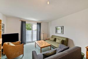 a living room with a couch and a table at Möve Aba Appartment 22 in Rerik