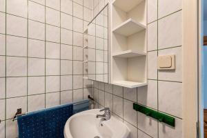 a bathroom with a sink and a mirror at Möve Aba Appartment 22 in Rerik +14 photos