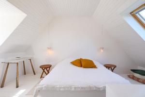 a white bedroom with a bed and a table at L'hermine - Villa de charme in Locquirec
