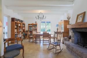 a dining room with a fireplace and a table and chairs at L'hermine - Villa de charme in Locquirec