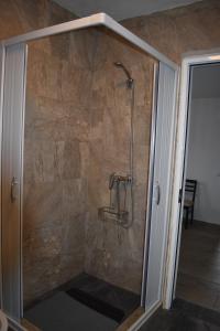 a shower in a room with a stone wall at Casa Trincadeira in Palmela