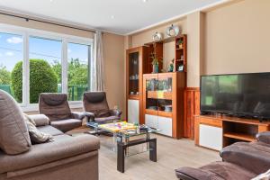 a living room with a flat screen tv and furniture at Casa La Manzana in Villaviciosa