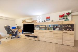 a large wooden entertainment center with a television in a room at Tulip Path 3 in Melle