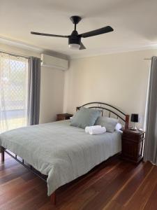 a bedroom with a bed with a ceiling fan at Garlin Corner in Leggs Island