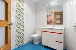 a bathroom with a toilet and a sink at Casa La Manzana in Villaviciosa +21 photos