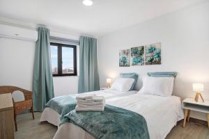 a bedroom with two beds and a window at Bouros's Cliff in Serra do Bouro