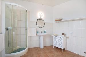 a bathroom with a shower and a sink and a mirror at Bouros's Cliff in Serra do Bouro +26 photos