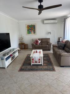 a living room with a couch and a table at Garlin Corner in Leggs Island