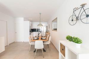 a kitchen and dining room with a table and chairs at Modern Apartment in Cómpeta I in Cómpeta +8 photos