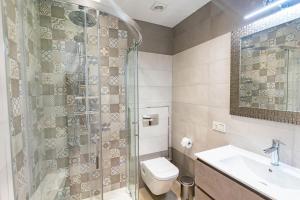 a bathroom with a shower and a toilet and a sink at Modern Apartment in Cómpeta I in Cómpeta