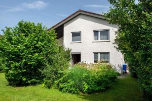 a white house with trees in front of it at Ferienhaus Christine Bodensee Nord in Pfullendorf