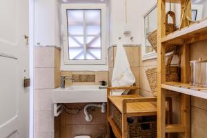 a small bathroom with a sink and a window at Sossego Alentejano in Reguengos de Monsaraz