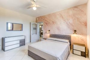 a bedroom with a bed and a ceiling fan at Villa Marilor in Salve +21 photos