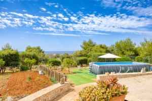 a garden with a swimming pool and a tent at Villa Marilor in Salve