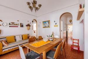 a dining room with a table and a couch at Sossego Alentejano in Reguengos de Monsaraz