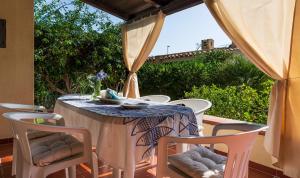 a table and chairs on a patio with a table and a window at Villa Lucia in Costa Rei