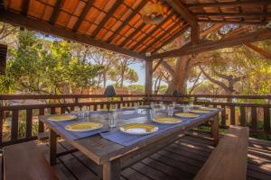 a wooden table with plates of food on it at Villa à 200m de la plage in Sainte-Maxime