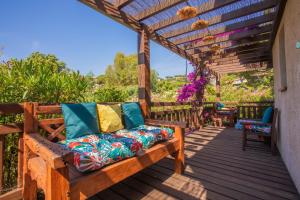 a wooden pergola with a couch on a deck at Villa à 200m de la plage in Sainte-Maxime
