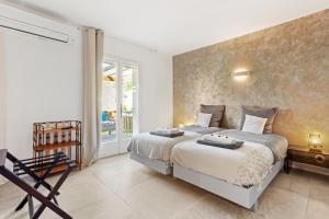 a bedroom with a large bed and a window at Villa à 200m de la plage in Sainte-Maxime +25 photos