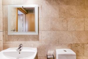 a bathroom with a sink and a toilet at Maritimo in Llança +16 photos