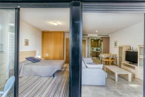 a bedroom with a bed and a living room at Maritimo in Llança