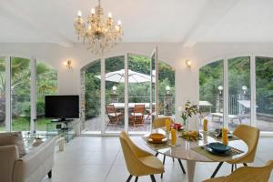 a dining room with a table and chairs and a television at Loggia Oliveto in Casanova Lerrore