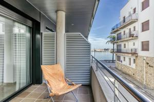 a chair on a balcony with a view of the ocean at Maritimo in Llança