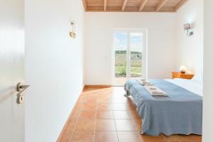 a white bedroom with a bed and a window at Paraiso da Serva - Flor do Rosto 1 in Odemira +28 photos
