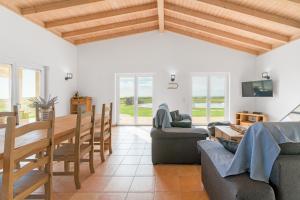 a living room with a table and a dining room at Paraiso da Serva - Flor do Rosto 1 in Odemira