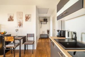a kitchen with a sink and a table at Haus Agatha in Wasserburg