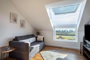 a living room with a couch and a window at Haus Agatha in Wasserburg