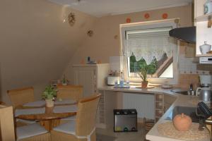 a kitchen with a table and a dining room at Ferienwohnung Gabi in Borken