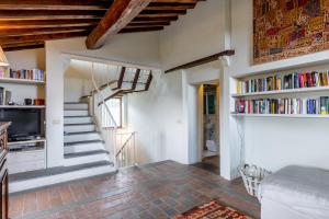 a room with a staircase with bookshelves at Greg's House in Santa Lucia