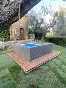 a swimming pool in a yard with a wooden deck at Greg's House in Santa Lucia