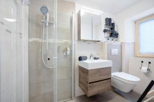 a bathroom with a shower and a sink and a toilet at Martin´s Alm in Friesenried +56 photos