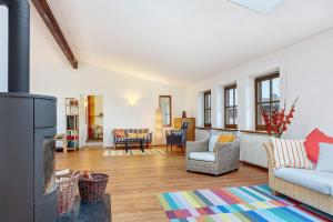 a living room with a couch and a fireplace at Atelierwohnung Hof Kranichmoor in Horst