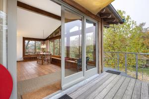 an open deck with sliding glass doors on a house at Atelierwohnung Hof Kranichmoor in Horst