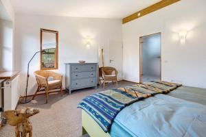 a bedroom with a large bed and a dresser at Atelierwohnung Hof Kranichmoor in Horst