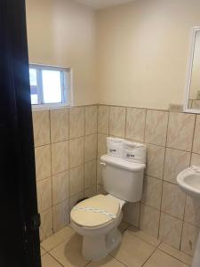 a bathroom with a toilet and a sink at Hotel Ranchito in Ensenada
