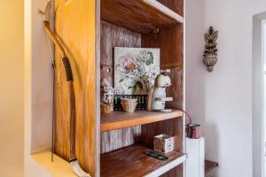 a room with a wooden shelf with items on it at Aquedarte in Lisbon