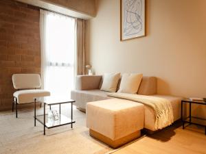 a living room with a couch and a chair at Mutuo Vive in Guadalajara +34 photos