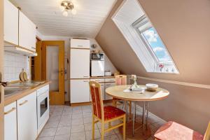 a kitchen with a small table and a window at Ferienwohnung Simonsen in Rabenkirchen-Faulück