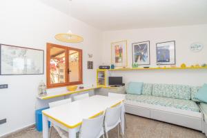 a living room with a couch and a table at House Punta Nera in Palau +16 photos