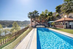 a swimming pool in front of a house at Porto Douro - Maison in Foz do Sousa